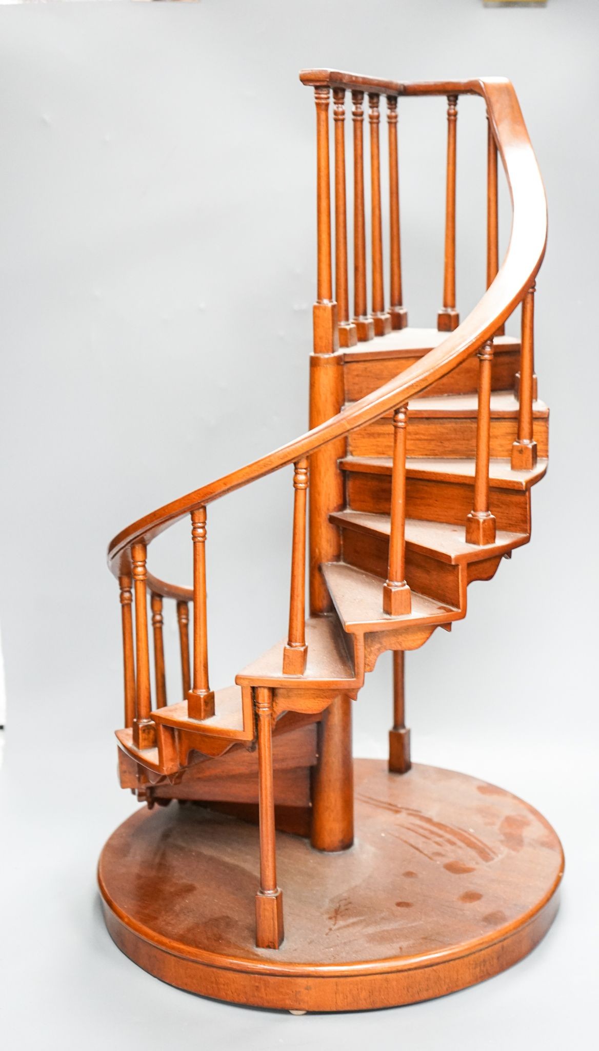 A large mahogany model of a spiral staircase 61cm